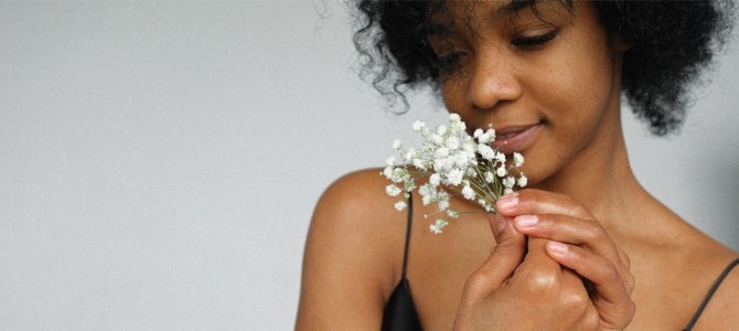 woman-in-black-tank-top-holding-baby-s-breath-flowers- by Anna Shvets women smelling baby's breath flowers