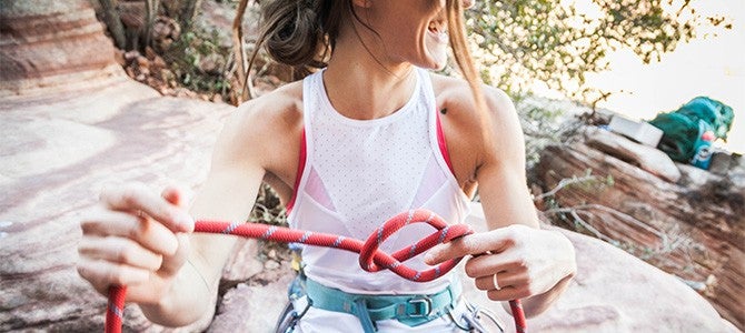Mental Wellness Image 03 girl tying a rope for rock climbing; Photo by Brooke Anderson on Unsplash