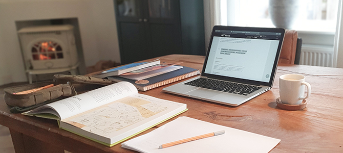 WFH Article Image 03 organized desk with laptop, books, and a notebook